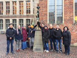 Doctoral researchers from Marburg visit the Bremen Town Musician. Touching the donkey’s hooves brings good luck.